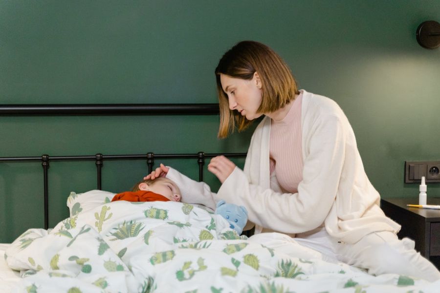 Photo by Tima Miroshnichenko: https://www.pexels.com/photo/close-up-shot-of-a-woman-with-her-sleeping-child-8376165/